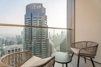a room with two chairs and a table and a window at GuestReady - 2BR l High-Rise Elegance in Dubai