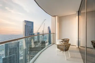 a balcony with chairs and a view of the city at GuestReady - 2BR l High-Rise Elegance in Dubai