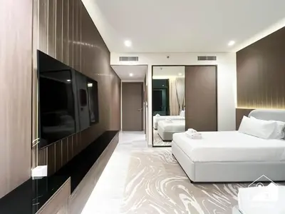 a hotel room with a bed and a television at Luxury Canal-View Retreat l 3BR with Balcony & Pool in Dubai