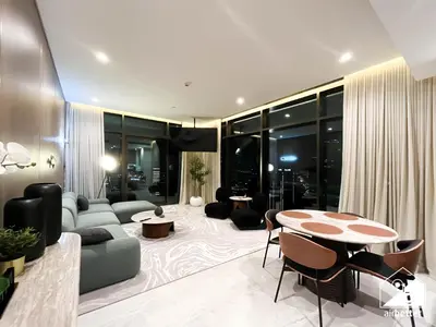 a living room with a couch and a table at Luxury Canal-View Retreat l 3BR with Balcony & Pool in Dubai