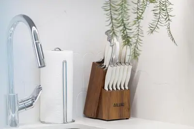 a block of toothbrushes in a holder next to a sink at Beachfront 1BR with Private Beach Access in Dubai