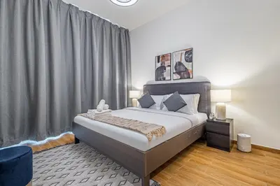 a bedroom with a bed and a large window at Best Business Bay Location - Direct Views of Canal and Al Khail Racecourse - 1 min from Al Habtoor Palace in Dubai