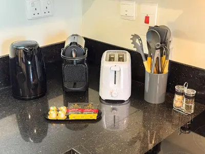 a counter top with a coffee maker on it at Best Business Bay Location - Direct Views of Canal and Al Khail Racecourse - 1 min from Al Habtoor Palace in Dubai