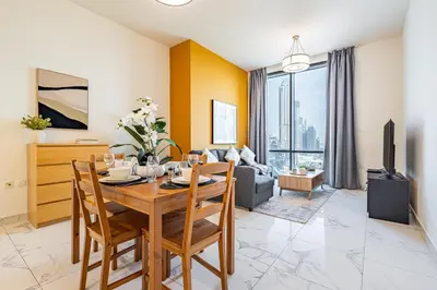 a living room with a table and a couch at Best Business Bay Location - Direct Views of Canal and Al Khail Racecourse - 1 min from Al Habtoor Palace in Dubai