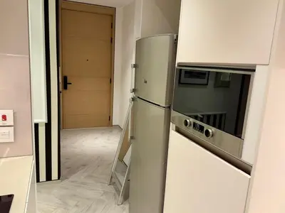 a kitchen with a stainless steel refrigerator and a hallway at JBR Beach Access Luxury1BR Marina View High Floor in Dubai