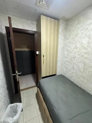 a bedroom with a bed and a door to a bathroom at Private Room Steps from Marina Beach Dubai in Dubai
