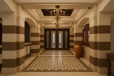an empty hallway with a chandelier and a door at Downtown Burj Khalifa View One Bedroom Apartment in Dubai