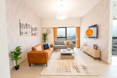 a living room with a couch and a table at EasyGo - Chic 2-Bedroom with Dubai Skyline View in Dubai