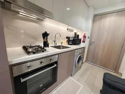 a small kitchen with a stove and a sink at Kanisha Homes Azizi Riviera 48 by Vacay Xeal in Dubai