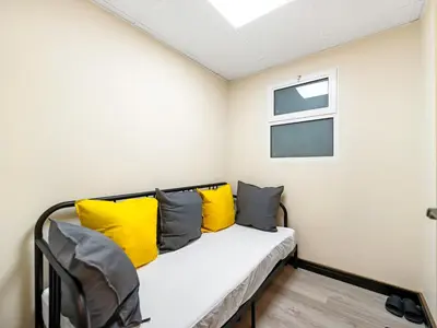 a room with a bed with yellow pillows at New Renovate Huge Flat w Canal & Burj Khalifa view in Dubai