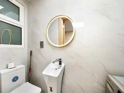 a bathroom with a white toilet and a mirror at New Renovate Huge Flat w Canal & Burj Khalifa view in Dubai