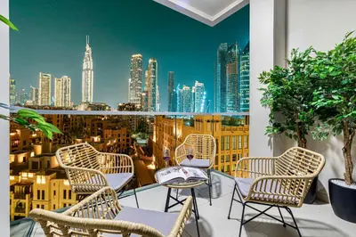 a balcony with chairs and a view of a city at Premium 3BR apartment with Burj Khalifa view, Downtown Dubai in Dubai