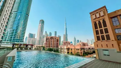 a large swimming pool on top of a building at Premium 3BR apartment with Burj Khalifa view, Downtown Dubai in Dubai