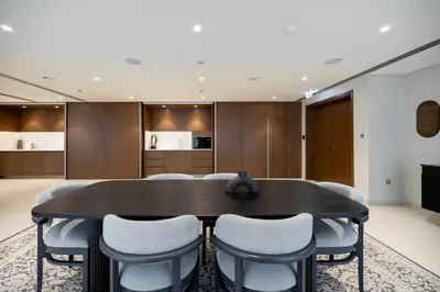 a dining room with a table and chairs at Palace Beach Residences By Luxe Living - Palm & Marina View in Dubai