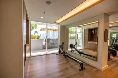 a fitness room with treadmills and a mirror at Palace Beach Residences By Luxe Living - Palm & Marina View in Dubai