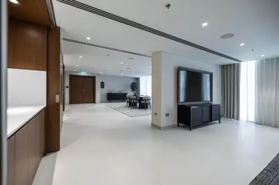 an empty lobby with a television and a living room at Palace Beach Residences By Luxe Living - Palm & Marina View in Dubai