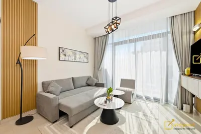 a living room with a couch and a table at 1BR Modern Escape in JVC Dubai in Dubai