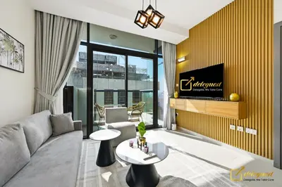 a living room with a couch and a tv at 1BR Modern Escape in JVC Dubai in Dubai