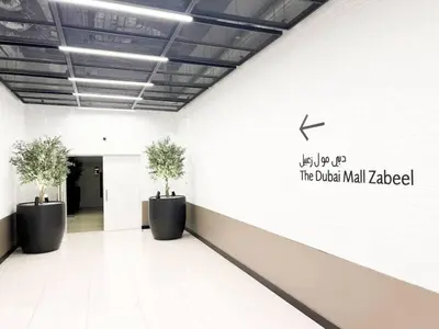 a hallway with two potted plants on a wall at Vogue Downtown Views II with Direct Access to Dubai Mall Via a Climate Controlled Bridge, One Bedroom Apartment with Balcony and City View in Dubai