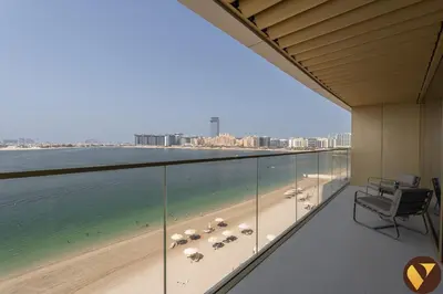 a balcony with a view of the beach and the ocean at Vogue Emaar Beachfront Grand Bleu Designed by Elie Saab, near JBR and Palm Jumeirah, Two Bedroom Apartment with Balcony and Private Beach, Access to all Amenities in Dubai