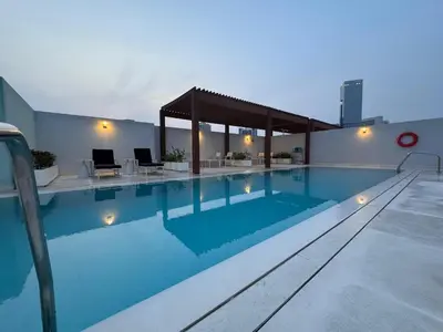 a large swimming pool on top of a building at Mahenti - Serene & Comfortable Apartment in Dubai