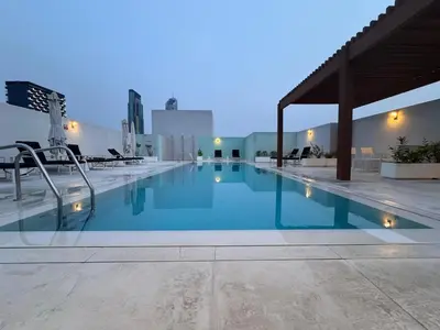 a large swimming pool on top of a building at Mahenti - Serene & Comfortable Apartment in Dubai