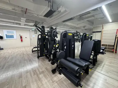 a gym with a bunch of treadmills and chairs at Mahenti - Serene & Comfortable Apartment in Dubai