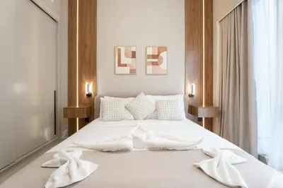 a bedroom with a white bed with towels on it at 1BR in GRANDE with Balcony I Amazing INFINITY POOL I Steps to Dubai Mall & Fountain in Dubai