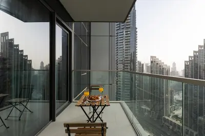 a balcony with a table and a view of a city at 1BR in GRANDE with Balcony I Amazing INFINITY POOL I Steps to Dubai Mall & Fountain in Dubai