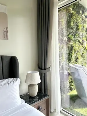 a bedroom with a bed and a window at Luxury 2BR with Dubai Canal View Near Burj Khalifa in Dubai