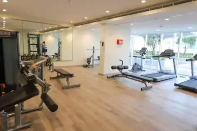 a gym with several treadmills and machines in a room at Luxury 2BR with Dubai Canal View Near Burj Khalifa in Dubai
