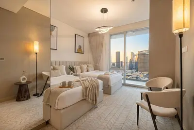 a hotel room with two beds and a large window at Vida Dubai Mall! 2 Bedroom with Burj Khalifa View! Direct Access to Dubai Mall in Dubai