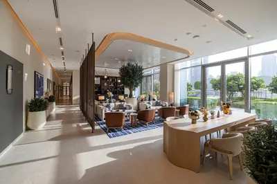 a lobby of a hotel with tables and chairs at Vida Dubai Mall! 2 Bedroom with Burj Khalifa View! Direct Access to Dubai Mall in Dubai