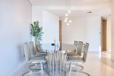 a dining room with a glass table and chairs at Burj Khalifa View High-Floor Upgraded 3Bed Apt in Dubai