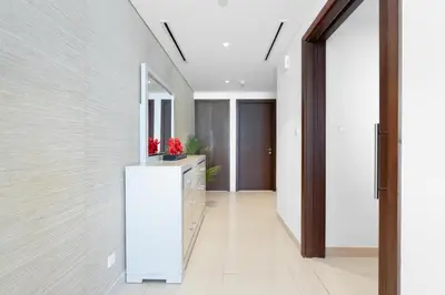 a hallway of a house with a white refrigerator at Boulevard Point I Burj Khalifa Fireworks View in Dubai