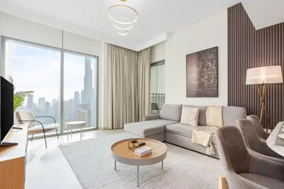 a living room with a couch and a table at King 2 Bedroom With Burj Khalifa View & Dubai Mall Access in Dubai