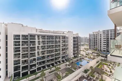an aerial view of a building with a pool at HAVN - Spacious 1 bedroom in Azizi Riviera, Meydan in Dubai