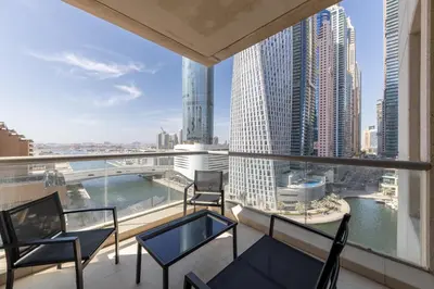 a balcony with chairs and a view of the city at Two Bedroom apartment - Dubai Marina in Dubai