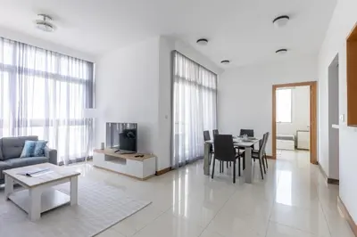 a living room with a couch and a table at Two Bedroom apartment - Dubai Marina in Dubai