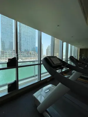 a gym in a building with a view of the city at Two Bedroom apartment - Dubai Marina in Dubai