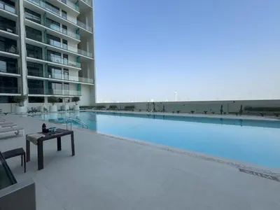a large swimming pool in the middle of a building at StayShort - Stylish Boho Studio in JVC Dubai Staycation Sleeps 2 in Dubai