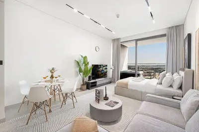 a bedroom with a bed and a living room with a tv at Studio Apartments with Private Jacuzzi - Spa - Cold Plunge - Gym in Business Bay in Dubai