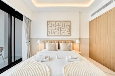 a bedroom with a large bed with two pillows at Cozy & Modern Studio Stay in Azizi Riviera Meydan in Dubai