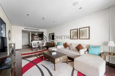 a living room with a couch and a table at Sea View 1BR - Private Beach Access Anantara in Dubai