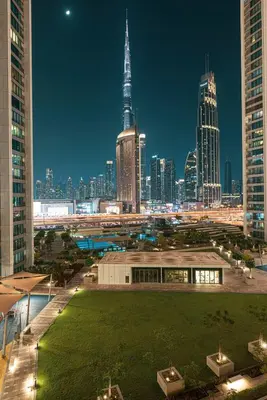 a view of a city skyline at night at Luxury 4BR Burj Khalifa View Dubai Mall in Dubai