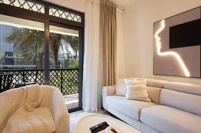 a living room with a white couch and a large window at Luxury 2BR in Dubai Downtown Steps to Burj Khalifa and Dubai Mall with Burj Khalifa View by La Brisa in Dubai