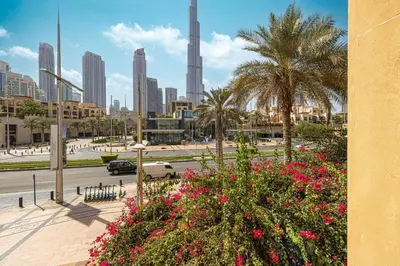 a view of a city with palm trees and flowers at Luxury 2BR in Dubai Downtown Steps to Burj Khalifa and Dubai Mall with Burj Khalifa View by La Brisa in Dubai