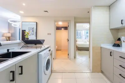 a kitchen with a sink and a washing machine at Prestigious 2BR with nice View of Marina Dubai in Dubai