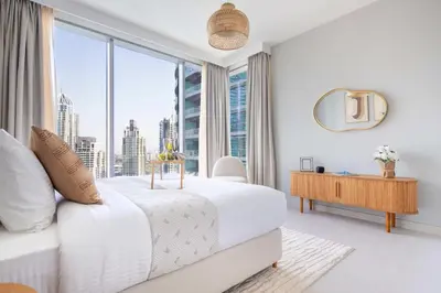 a bedroom with a white bed and a large window at Frank Porter - Liv Marina in Dubai