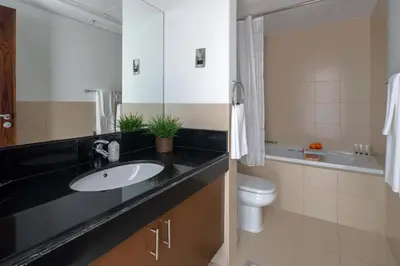 a bathroom with a sink and a toilet at Frank Porter - Boulevard Walk Downtown in Dubai